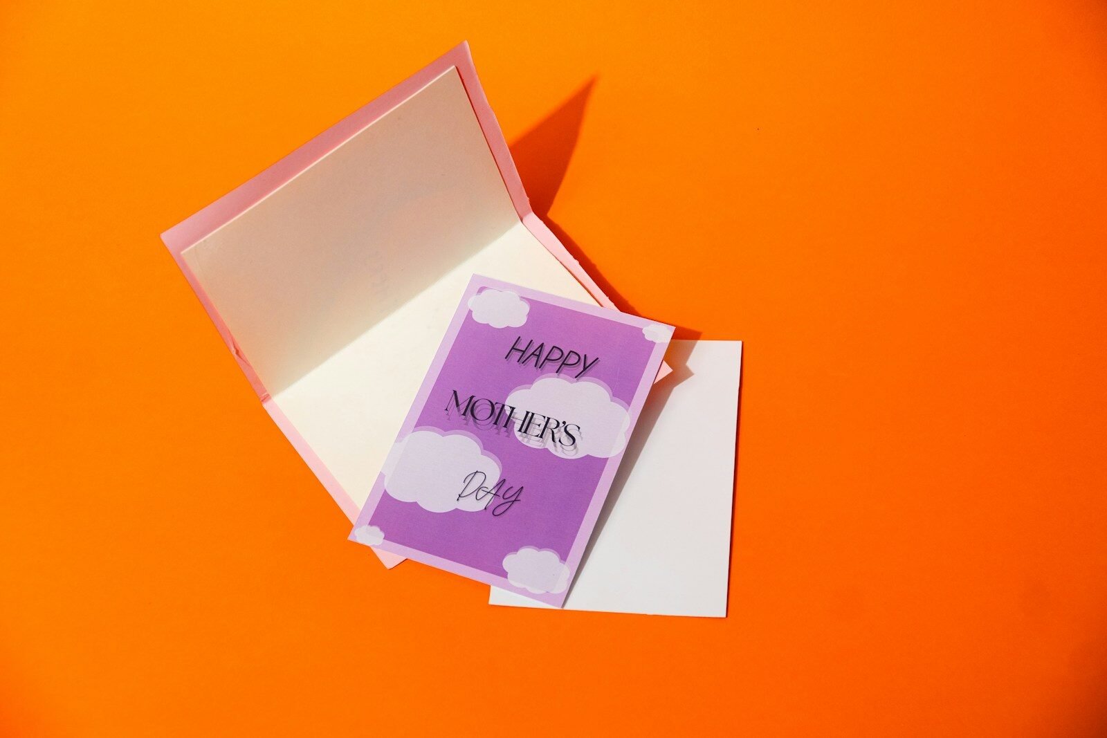 A purple card with clouds says happy mother's day